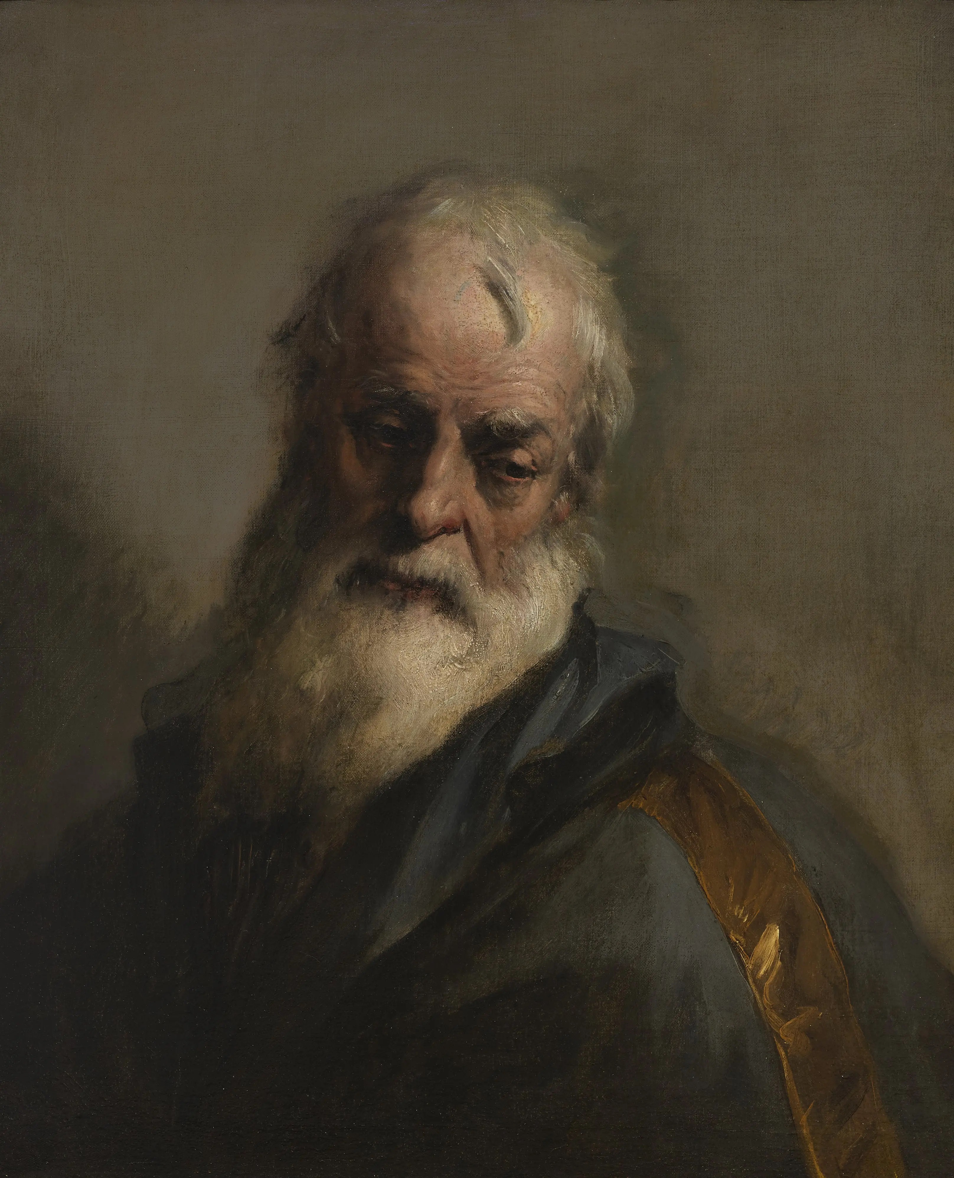 The head of a bearded man looking down